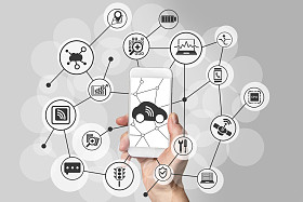 用手拿着现代的智能手机，在中性的背景前连接概念车