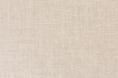 中性米色织物背景与明确的画布纹理