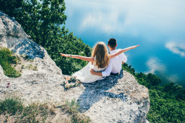 美丽的夫妇在岩石上摆姿势照片