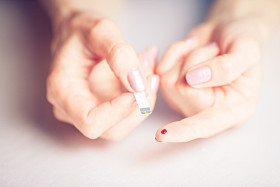 People concept - close-up of female finger blood drops and T