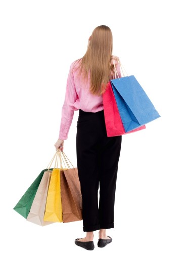 后視圖的購物袋的女人 .圖片