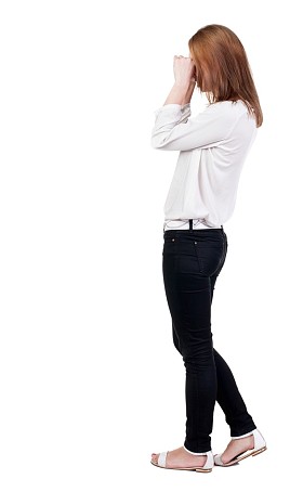 震惊的女人在裤子后面观.图片