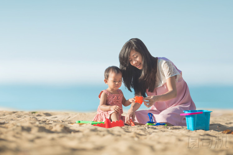 在海灘的母親的小女孩  圖片