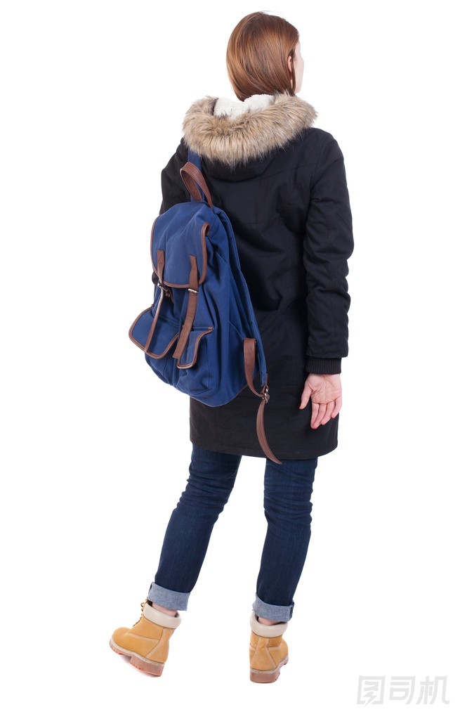 在冬季夾克與查找一個(gè)背包的背影女人