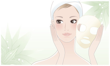 美丽的女孩，年轻女子后美容面膜绿色小花的背景上摸她的脸