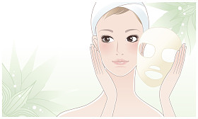 美丽的女孩，年轻女子后美容面膜绿色小花的背景上摸她的脸