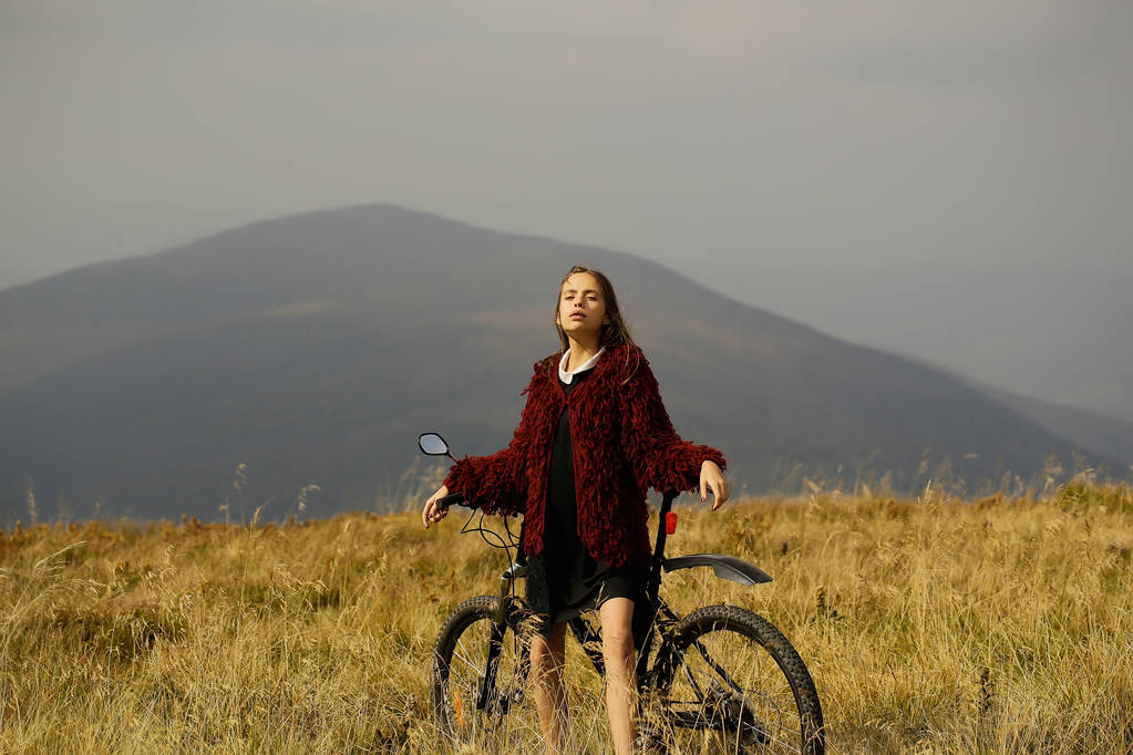 山上的自行车的女孩照片