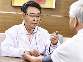 亚洲医生检查一位高龄患者血压