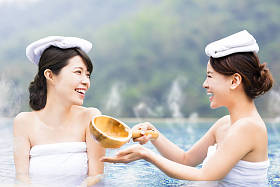 幸福的年轻女人在温泉中休息