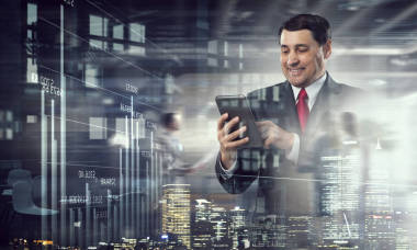 高级商人使用平板电脑。混合媒体