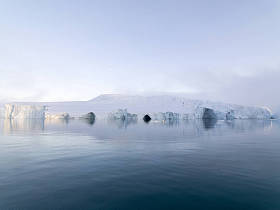 Arctic icebergs in the Arctic sea of Greenland. You can easily see the iceberg above and below the water. Sometimes it is hard to believe that 90 percent of an iceberg is under water