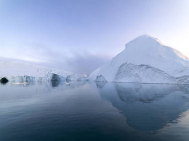 Arctic icebergs in the Arctic sea of Greenland. You can easily see the iceberg above and below the water. Sometimes it is hard to believe that 90 percent of an iceberg is under water