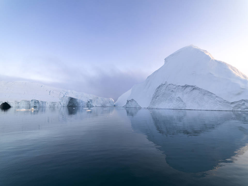 Arctic icebergs in the Arctic sea of Greenland. You can easily see the iceberg above and below the water. Sometimes it is hard to believe that 90 percent of an iceberg is under water Arctic icebergs in the Arctic sea of Greenland. You can easily see the iceberg above and below the water. Sometimes it is hard to believe that 90 percent of an iceberg is under water