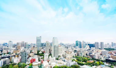 Concept of business and Culture -- modern city skyline panoramic aerial view from Tokyo Tower below the dramatic blue morning cloudy sky in Tokyo, Japan