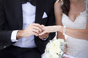 把结婚戒指放在她的新娘新郎