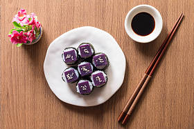 Sushi - Purple sweet potato on sushi rice white ceramic plate. The purple-heart sweet potato benefits from high beta-carotene and cooking carbohydrates. Top view