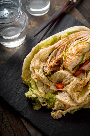 泡菜在垂直的黑色石頭背景圖片