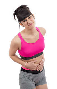 年轻女孩吃胃疼，在白色.图片