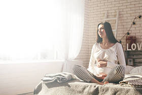 怀孕的女人在床上照片