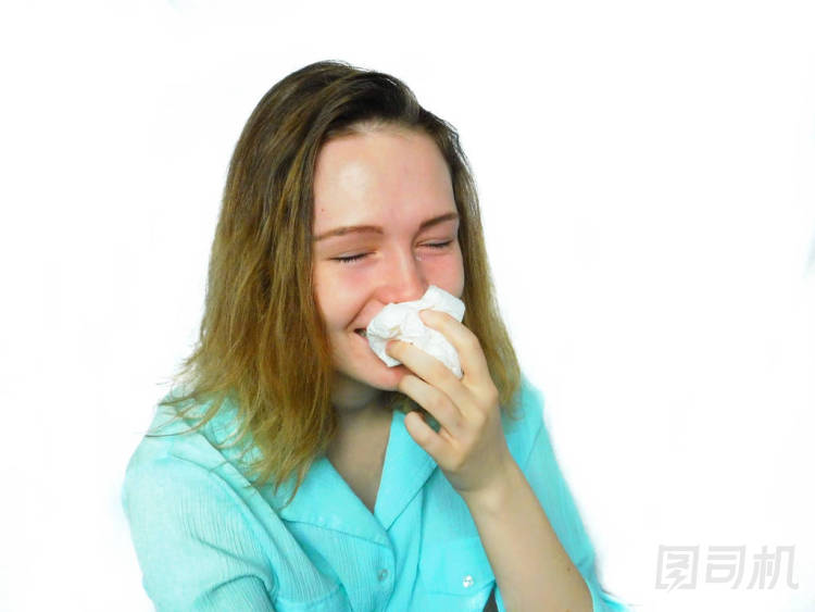 情感的女孩在擦她的鼻子