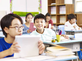 亚洲小学学生在课堂中使用平板电脑