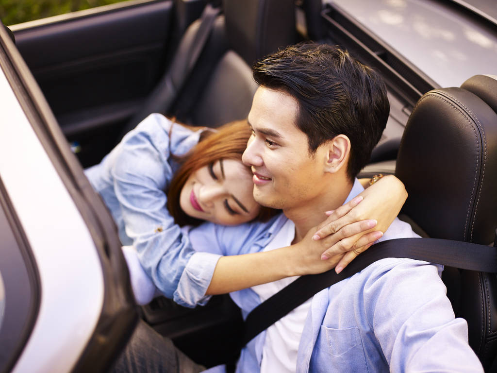 亚洲夫妇骑在一辆跑车 亚洲夫妇骑在一辆跑车