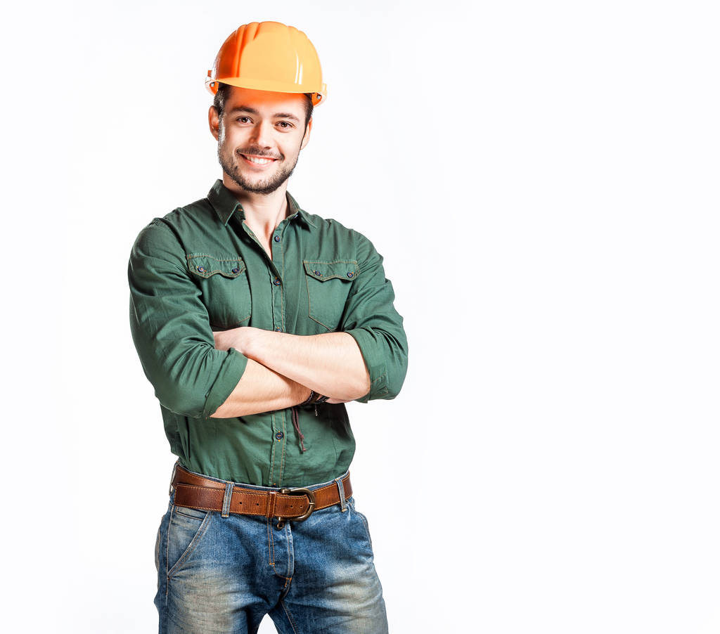 年轻的建筑工人的安全帽照片 年轻的建筑工人的安全帽照片