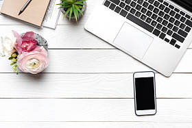 笔记本电脑和桌上的智能手机照片