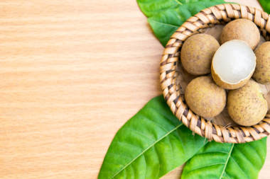 鲜龙眼龙眼叶木桌上设置图片