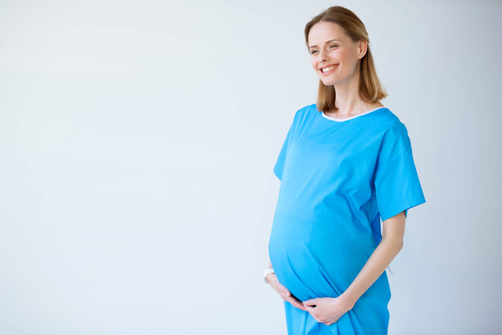 怀孕的女人，摸她的肚子图片