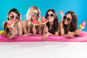 多民族的女孩躺在游泳床垫