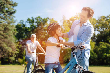 照顧好爸爸穿上他的兒子的頭盔