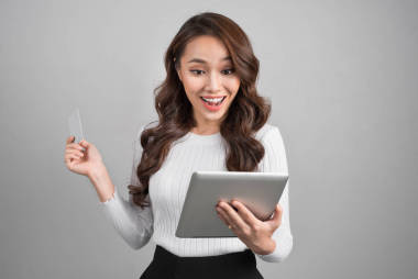 年輕的亞裔女子和平板電腦圖片