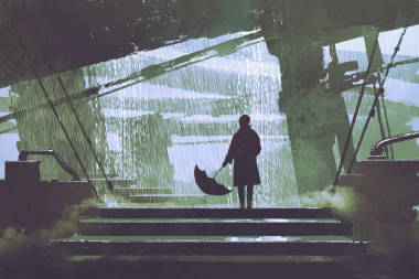 傘的人站立在下雨天的建筑