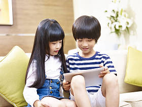 亚洲的弟弟和妹妹使用数字平板电脑