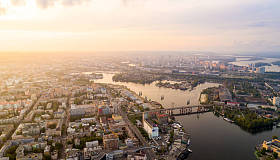 An aerial view of the panorama of the Old part of the city - Podal District. Sunset view of Rybalsky Island