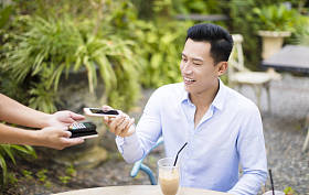 男人付钱给条例草案通过智能手机使用中餐馆的 Nfc 技术 