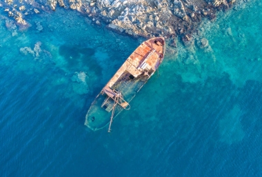一艘老沉船被遺棄在海灘上圖片