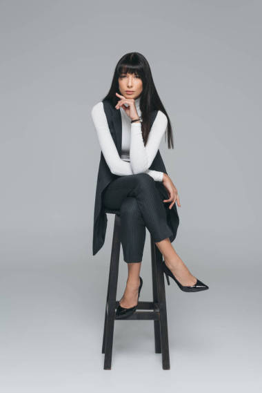 有吸引力的黑發(fā)女子休息下巴上的灰色隔離