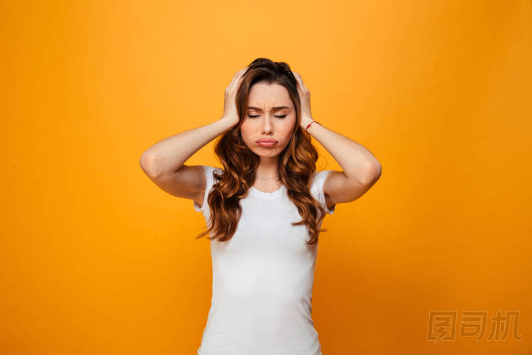 穿著 t恤衫的黑發(fā)女人抱著她的頭