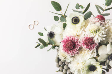 美麗的新娘花束和結(jié)婚戒指在灰色的頂部視圖