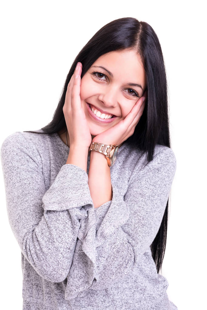 摄影棚拍摄一个美丽的年轻的休闲妇女与手上的脸 摄影棚拍摄一个美丽的年轻的休闲妇女与手上的脸