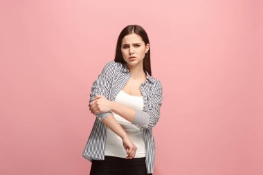 肘部疼痛。在粉红色工作室背景下, 肘部疼痛或疼痛的悲伤妇女
