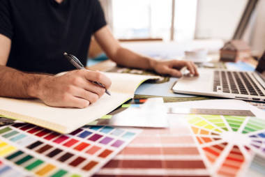 自由职业者胡子男子在笔记本电脑坐在办公桌上笔记