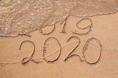 新年2020是未來概念-題字2019和2020沙灘沙子, 波浪幾乎覆蓋數(shù)字2019