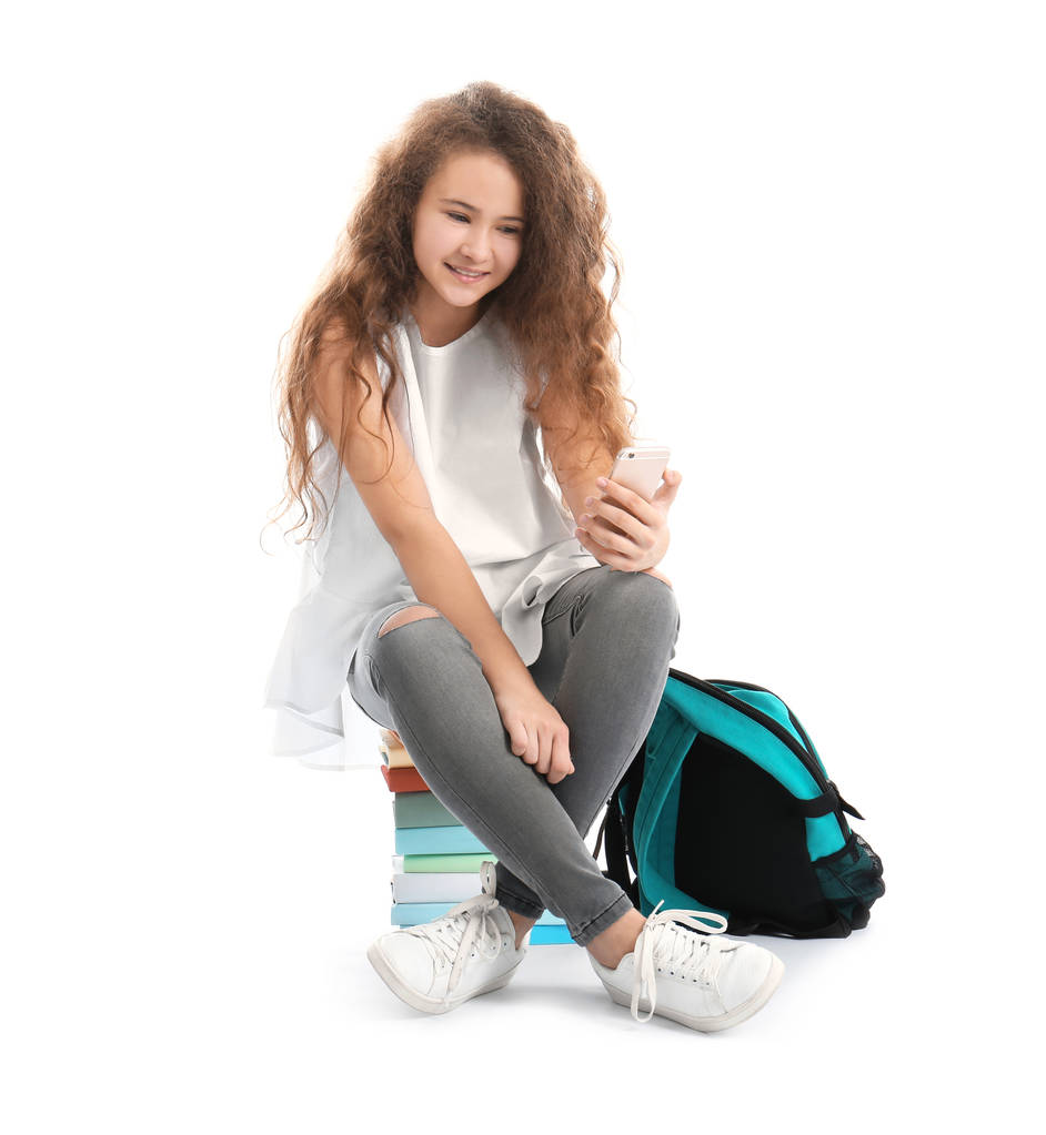 时髦的青少年坐在书上  照片 时髦的青少年坐在书上  照片