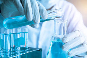 具有用于分析、医疗、制药和科学研究概念的液体玻璃实验室化学试管的研究人员