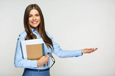 微笑的婦女老師拿著練習(xí)本和指向權(quán)利 