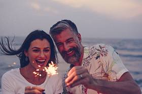夫妇庆祝与烟花在海滩图片