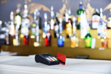 在弥散背景下插入读卡器的红色银行卡 在弥散背景下插入读卡器的红色银行卡